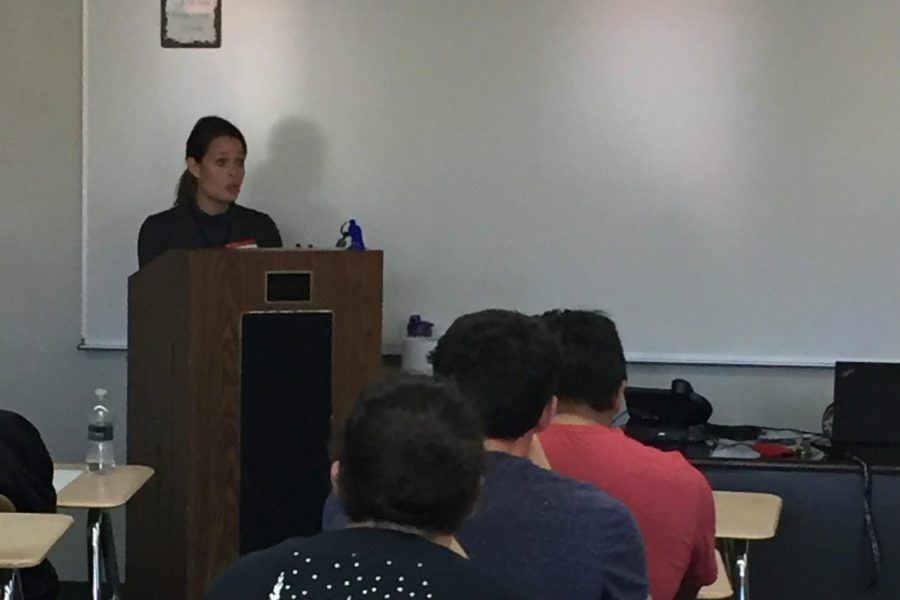(Photo courtesy of Bettina Plesnitzer) Speaker Maryann Miller tells the story of a family members struggle with opioid addiction during a lecture Nov. 3 in P.E. classes.