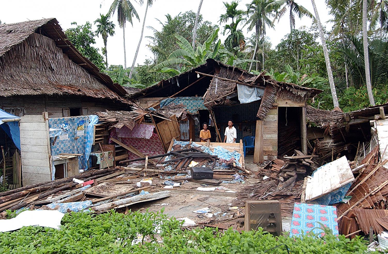 Indonesia Earthquake caused a great deal of destruction. This photo shows a man standing before his home after it was obliterated.