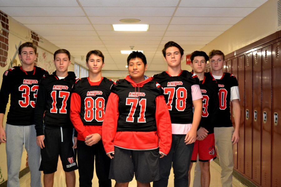 Football players show off their new uniforms.