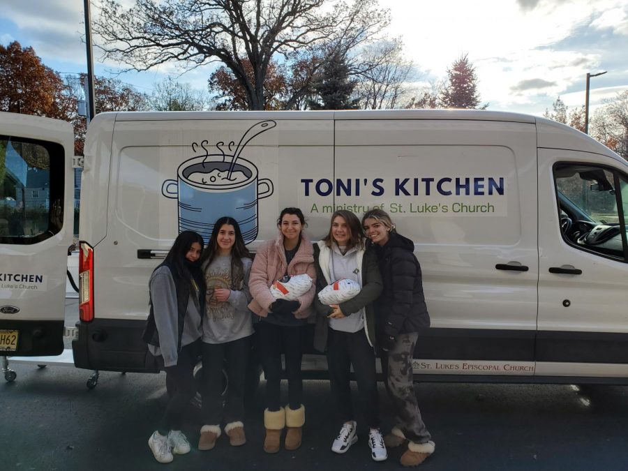 (From left) Melilah Sanchez, Micah Kamenetskiy, Daniella Pastena, Kelly Cammarata, and Olivia DAchille, members of the Cooking 4 A Cause Club, pose with their food donations to Tonis Kitchen.
