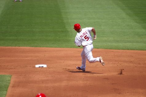 Albert Pujols rounds second base in a cardinals unfirom during his final season, while chasing history. 