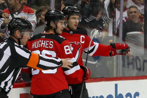 New Jersey Devils captain Nico Hischier (right), and assistant captain Jack Hughes celebrate during a game. The two have been a key part of the Devils successes throughout the early part of the season.