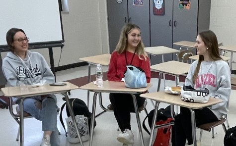 (From left) Sarah Chodorcoff, Evie Minnella and Lauren Hain, participants in the ELL tables, discuss different topics with English language learners.