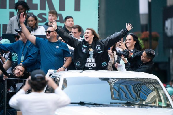 Ionescu celebrates WNBA title with fans during championship parade in New York City.