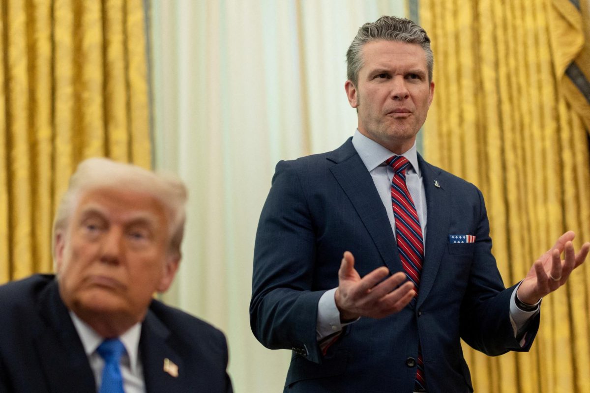 U.S. Defense Secretary Pete Hegseth speaks next to President Donald Trump, in the Oval Office at the White House, in Washington, D.C., U.S., March 21, 2025. REUTERS/Carlos Barria