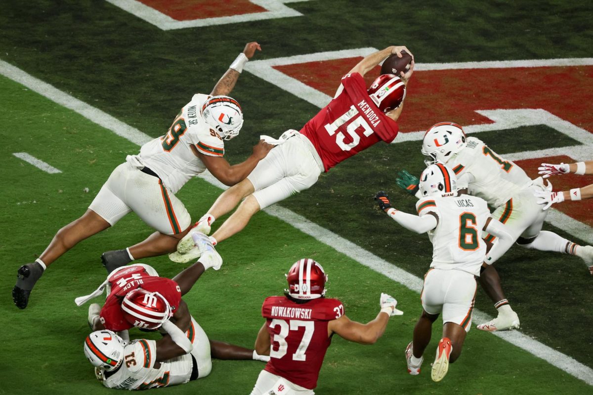 Jan 19, 2026; Miami Gardens, FL, USA; Indiana Hoosiers quarterback Fernando Mendoza (15) carries the ball for a touchdown against the Miami Hurricanes in the fourth quarter during the College Football Playoff National Championship game at Hard Rock Stadium. Mandatory Credit: Kim Klement Neitzel-Imagn Images