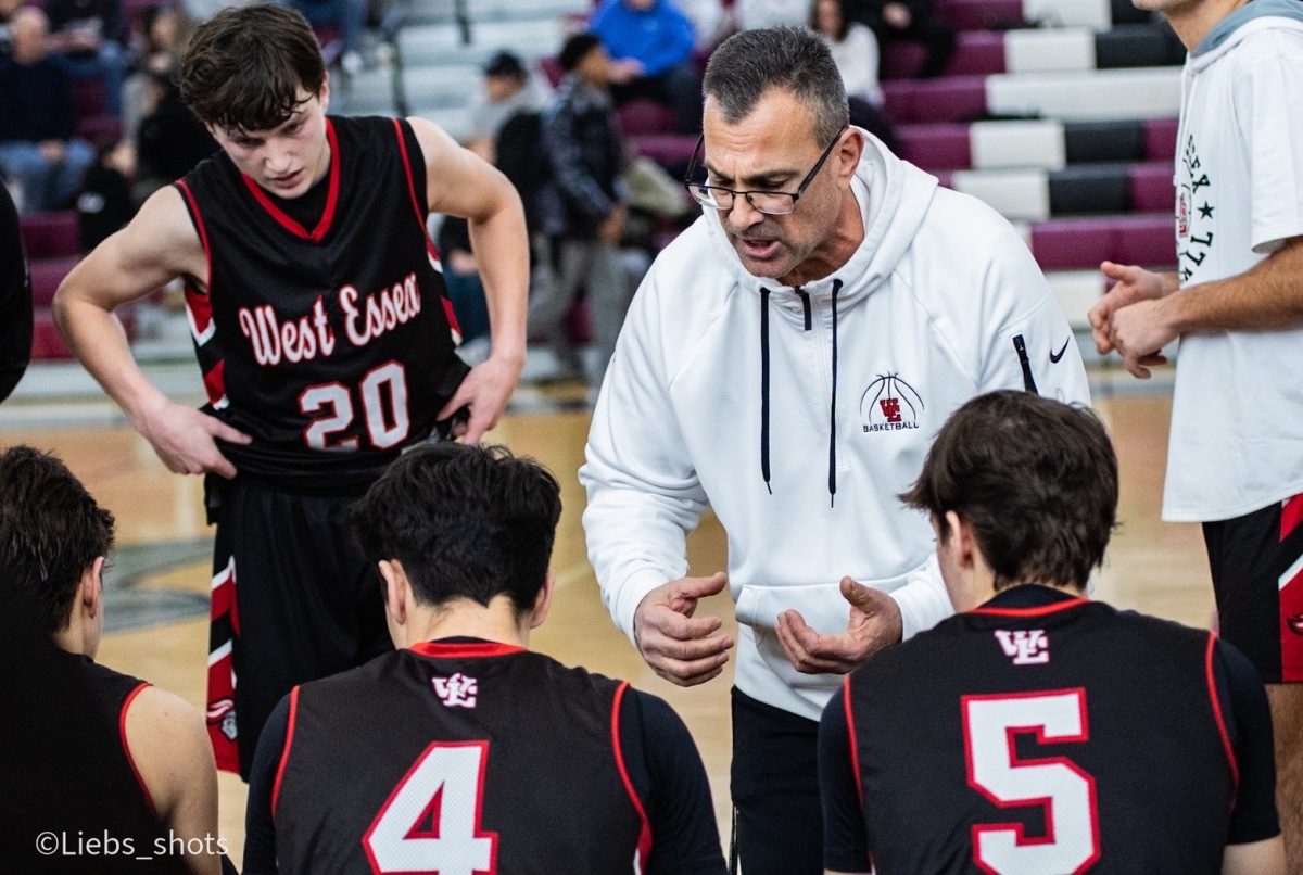 Coach Humes giving a pep talk to his players about gameplay and advice to help succeed in their matchup.