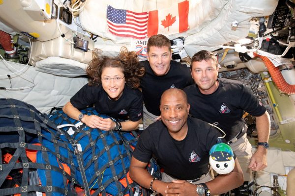 The NASA Artemis II crew poses for a group photo inside the Orion spacecraft on their way home following a fly-by of the far side of the Moon on April 6, 2026.
