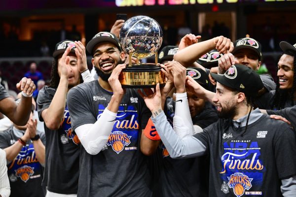 May 25, 2026; Cleveland, Ohio, USA; New York Knicks center Karl-Anthony Towns (32) and guard Jose Alvarado (5) help the team lift the trophy after defeating the Cleveland Cavaliers in game four of the eastern conference finals for the 2026 NBA playoffs at Rocket Arena. Mandatory Credit: Ken Blaze-Imagn Images